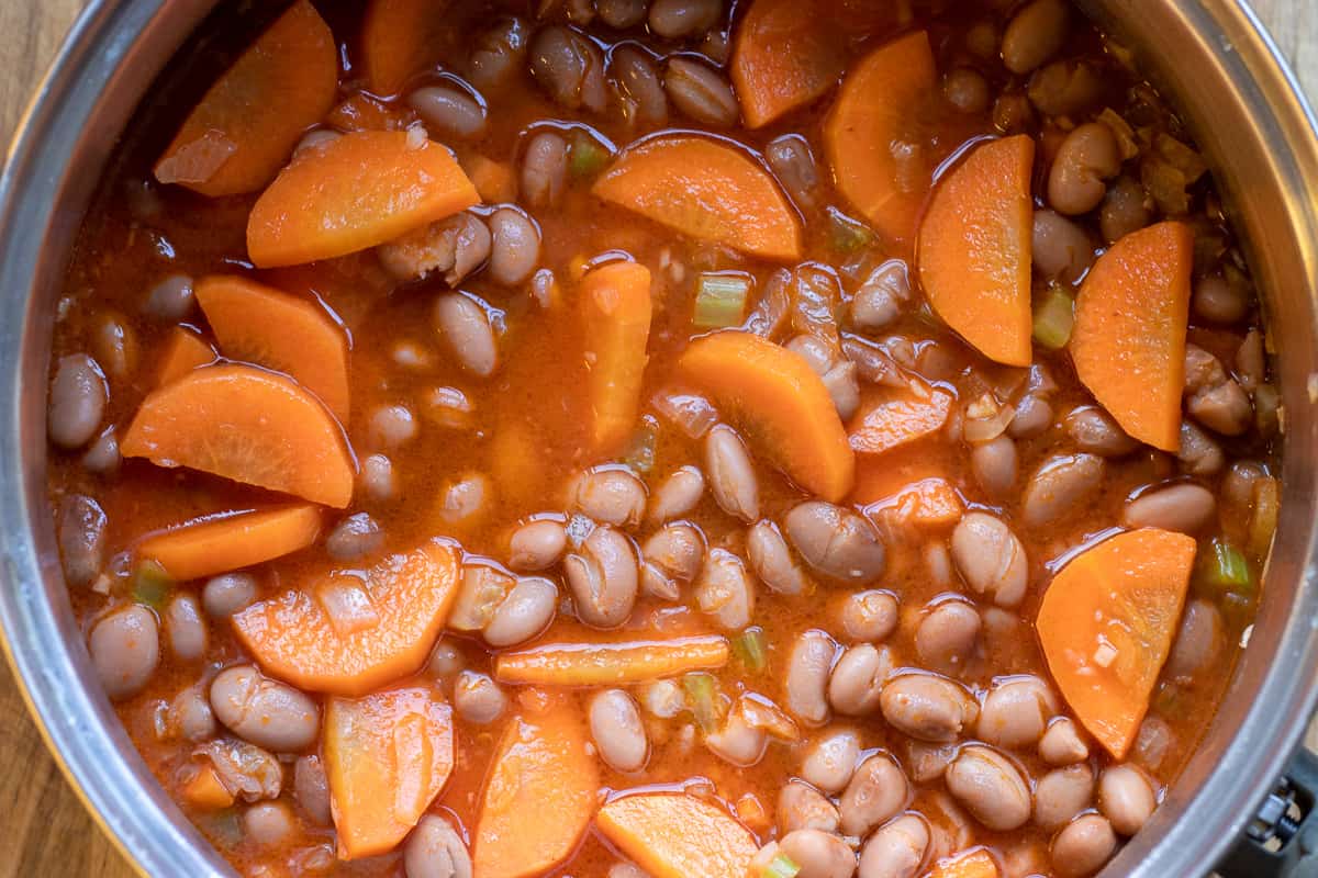 the beans and stock are added to the pan