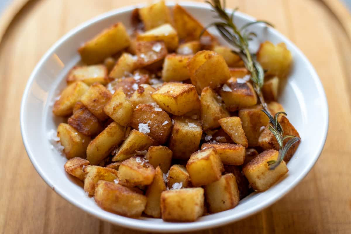 crispy saute potatoes garnished with sea salt and rosemary