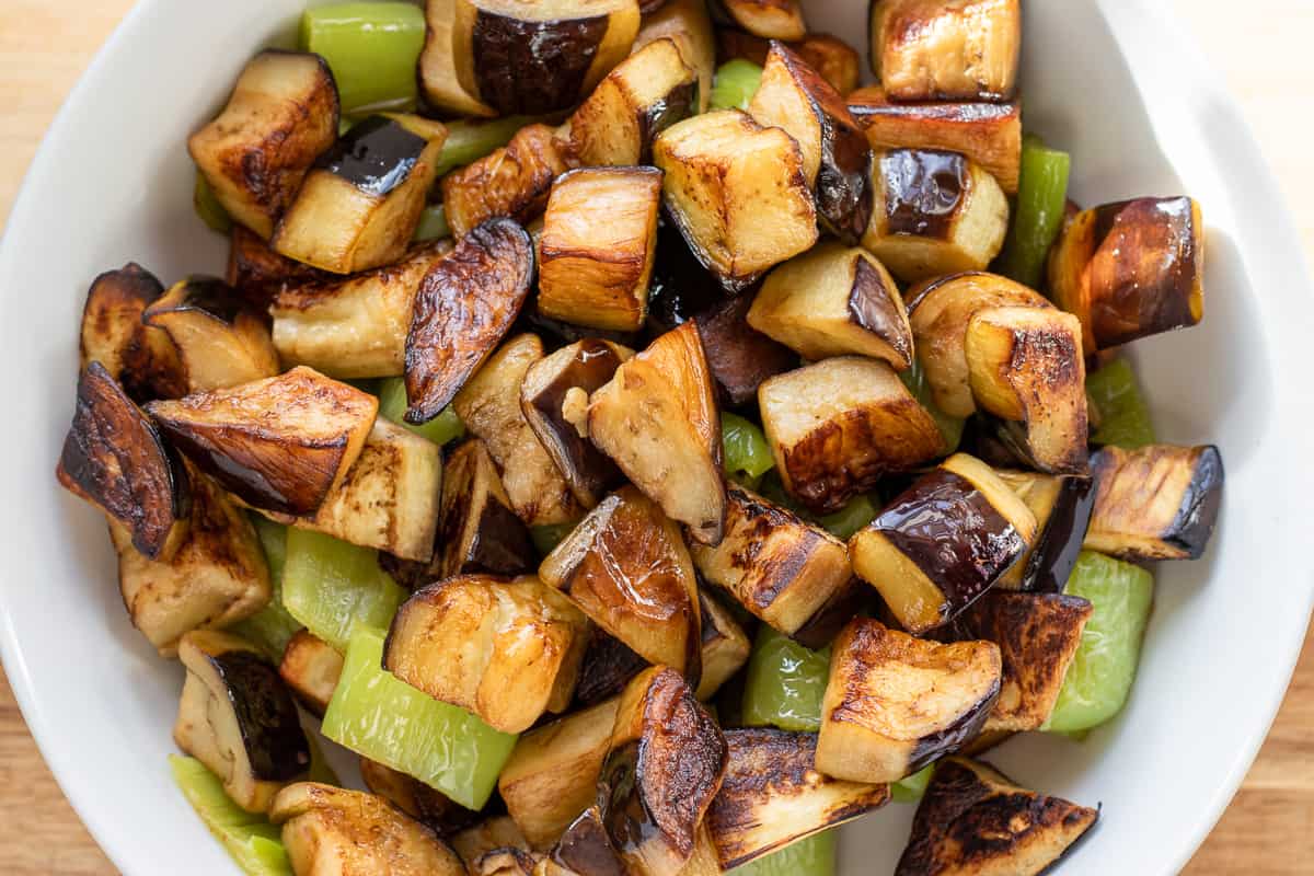 add the fried aubergines to peppers and potatoes