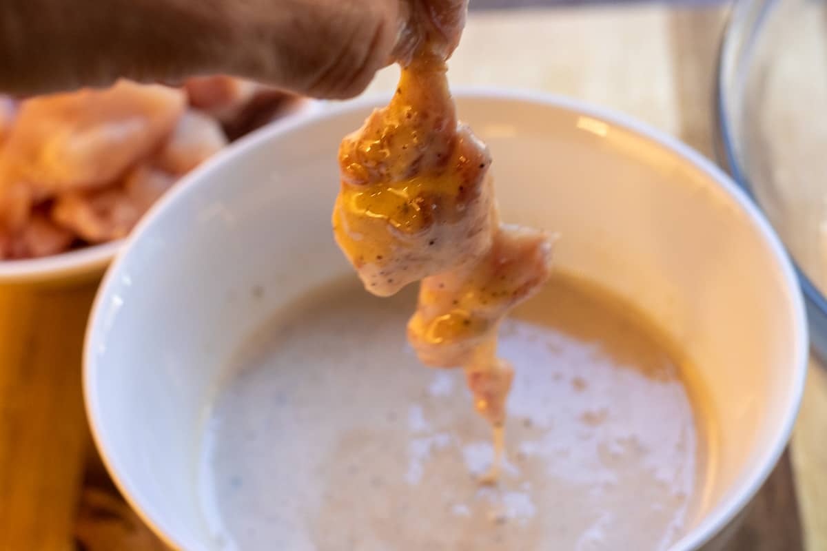 covering the chicken pieces with batter