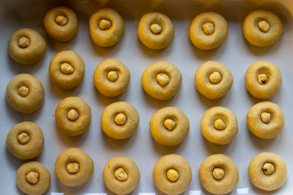 a piece of hazelnut is placed on each cookies