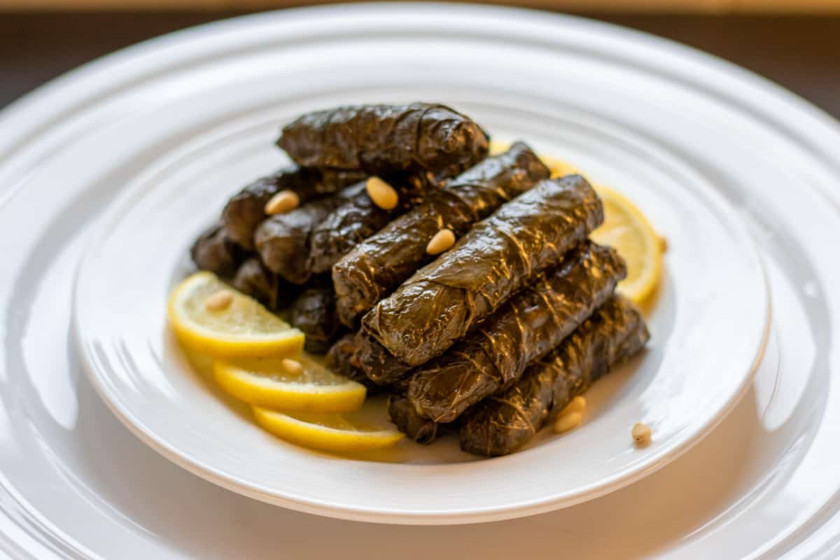 Yaprak Sarma - stuffed grape leaves served with lemon slices