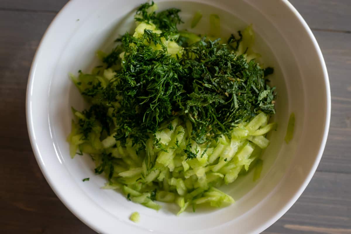 herbs are added to the grated cucumbers