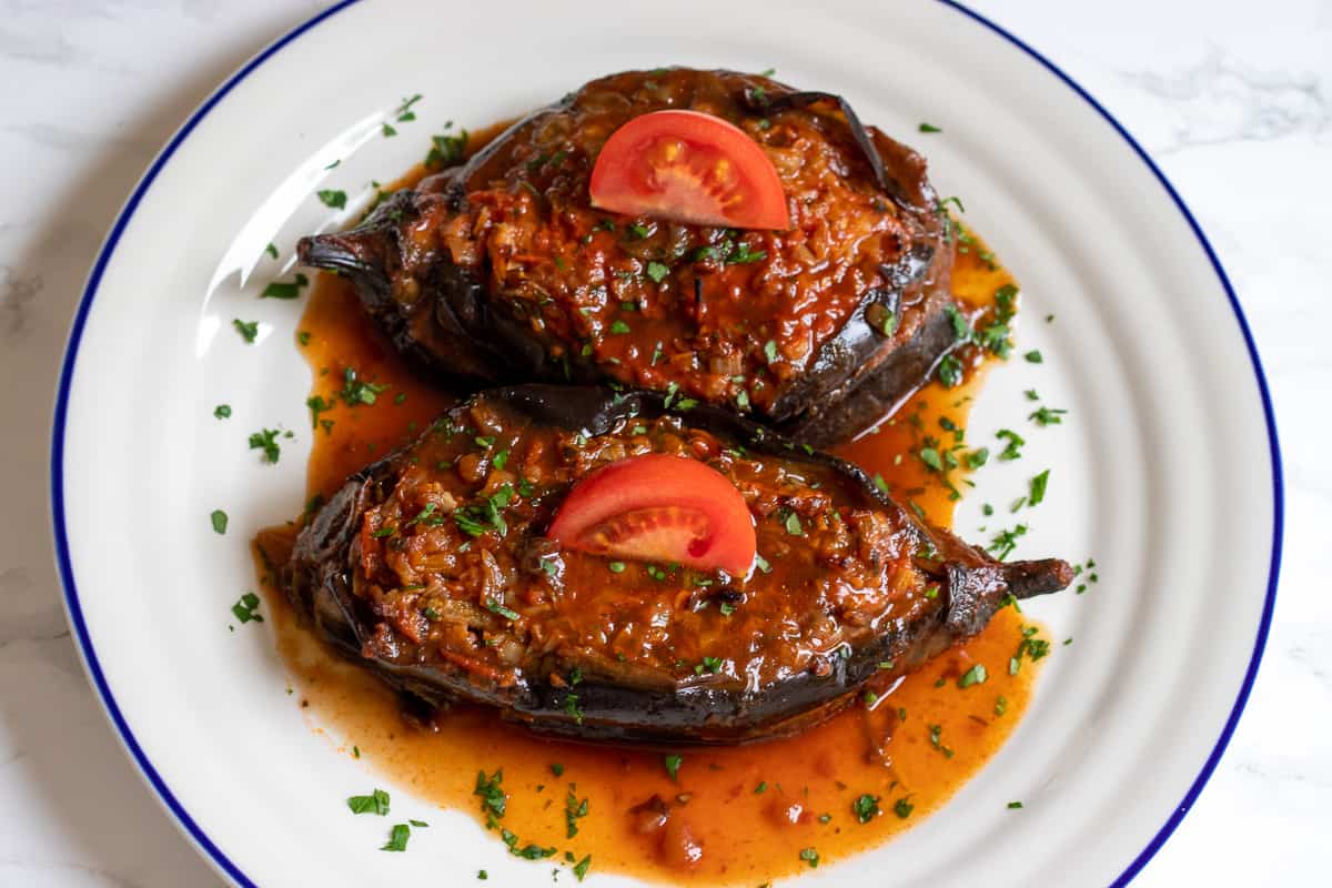 2 pieces of Imam Bayildi (Turkish stuffed eggplant) served on a plate