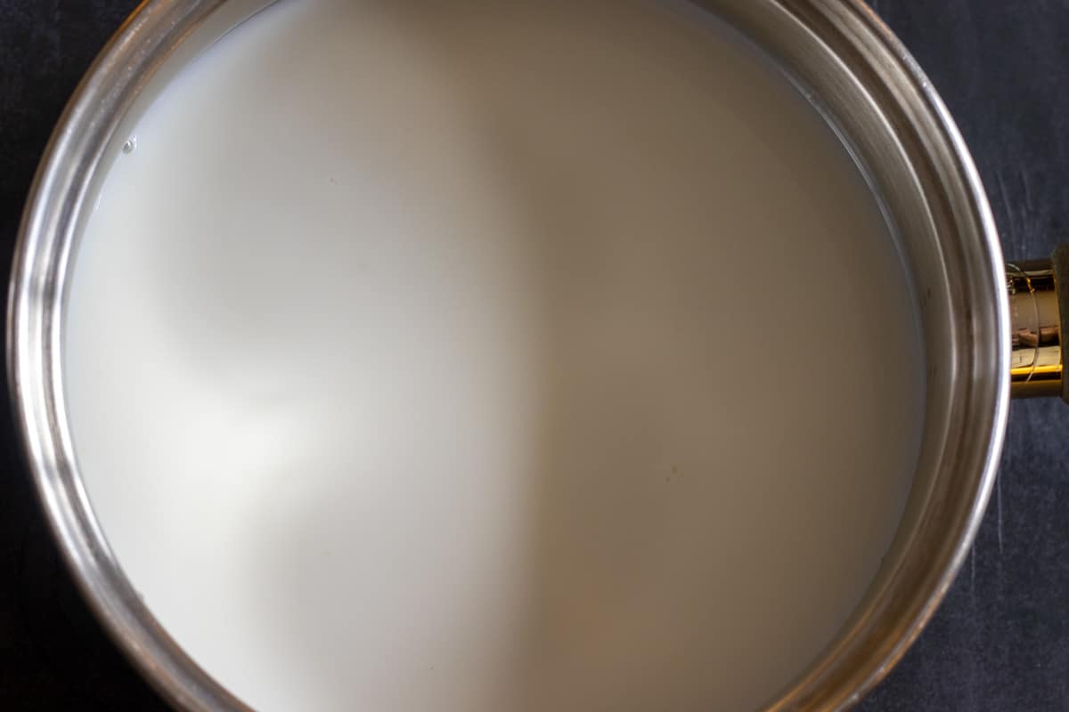 Sugar, milk and water are combined in a pan to make syrup for semolina halva