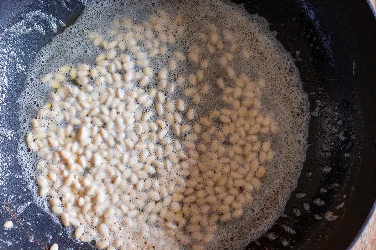 Sautéing the pine nuts in butter for making Irmik Helvasi