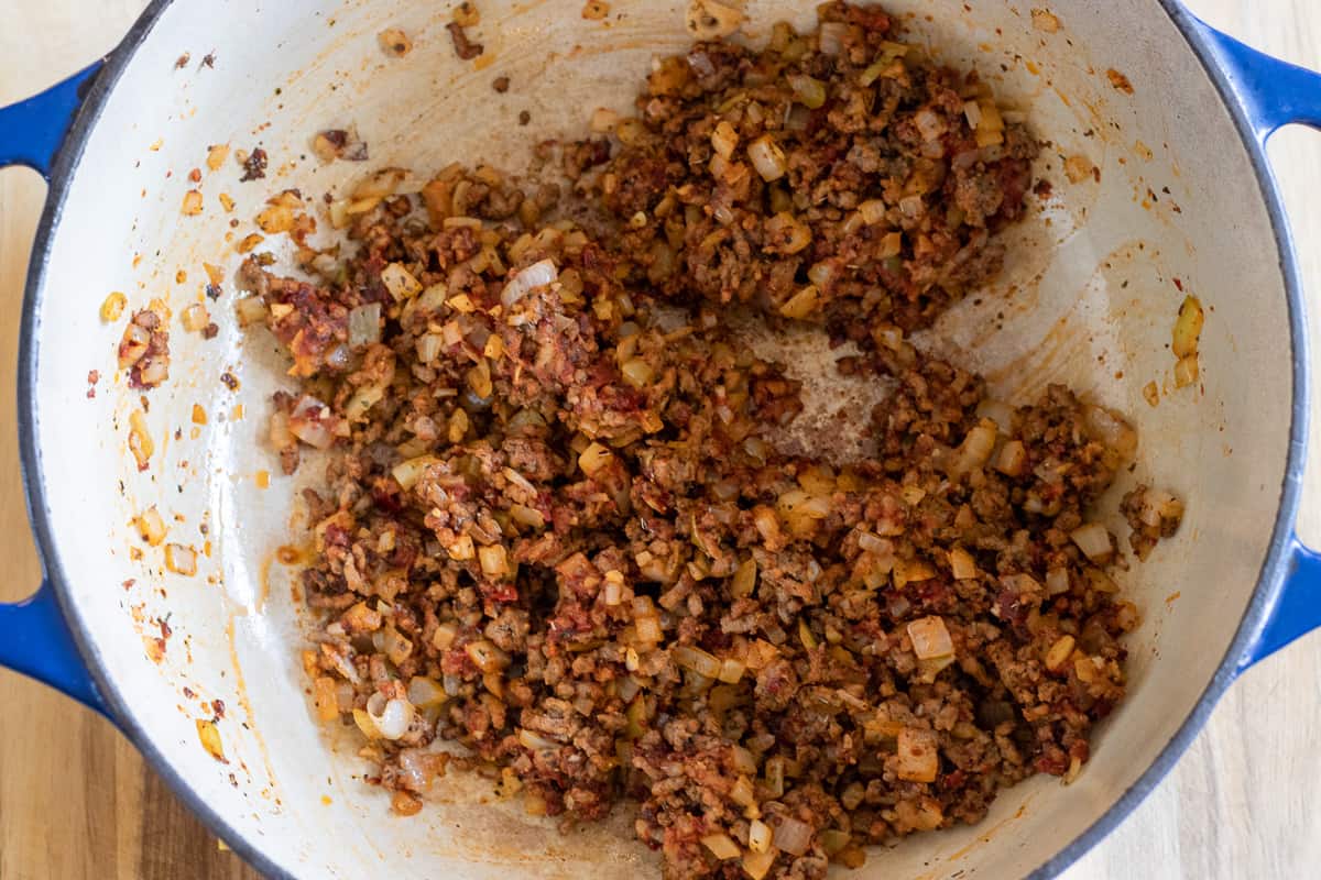 the tomato paste and spices are added to the mince
