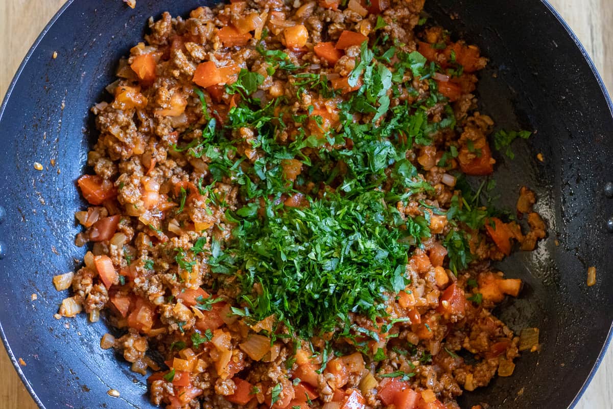 Finely chopped parsley is added to the pan