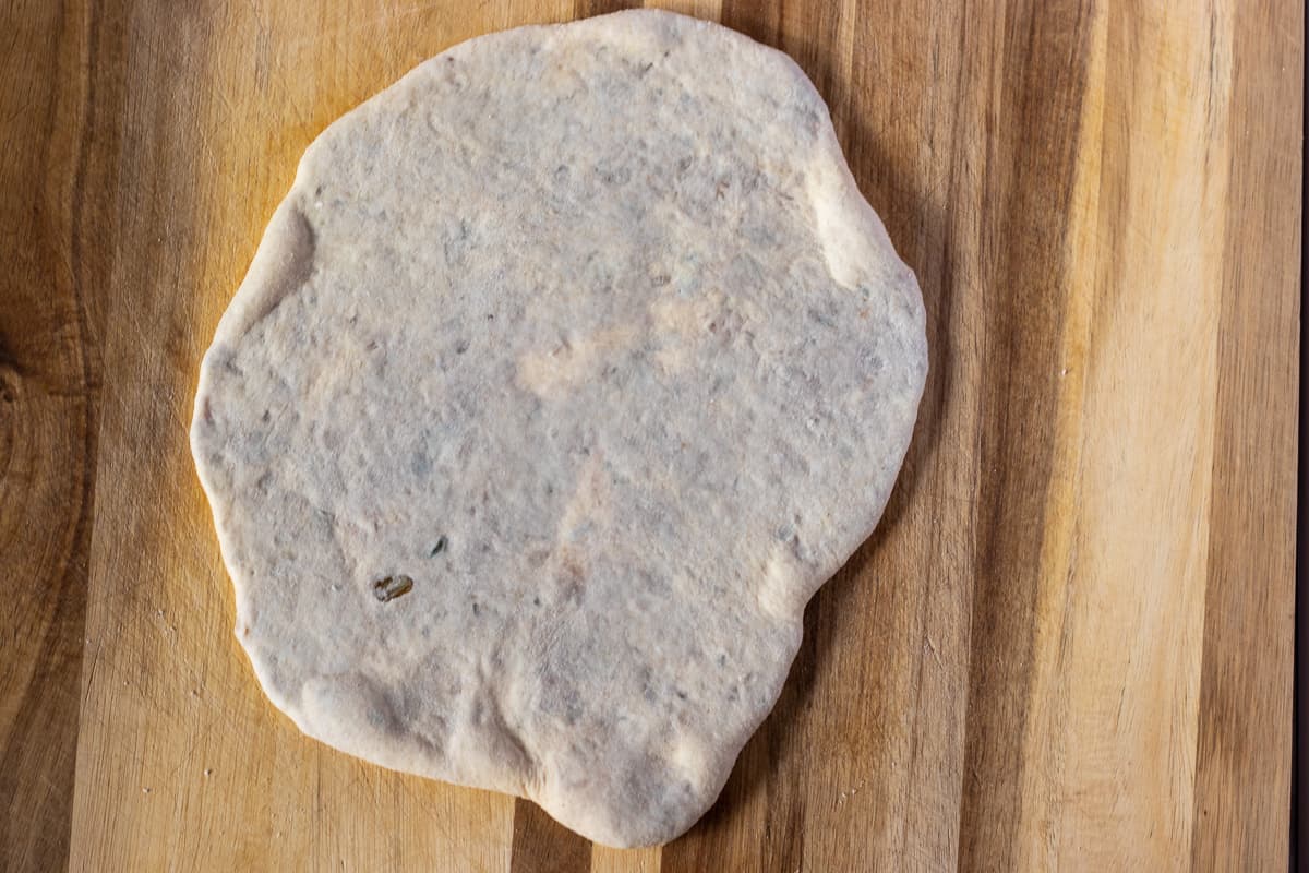the dough ball is rolled out into an oval shape