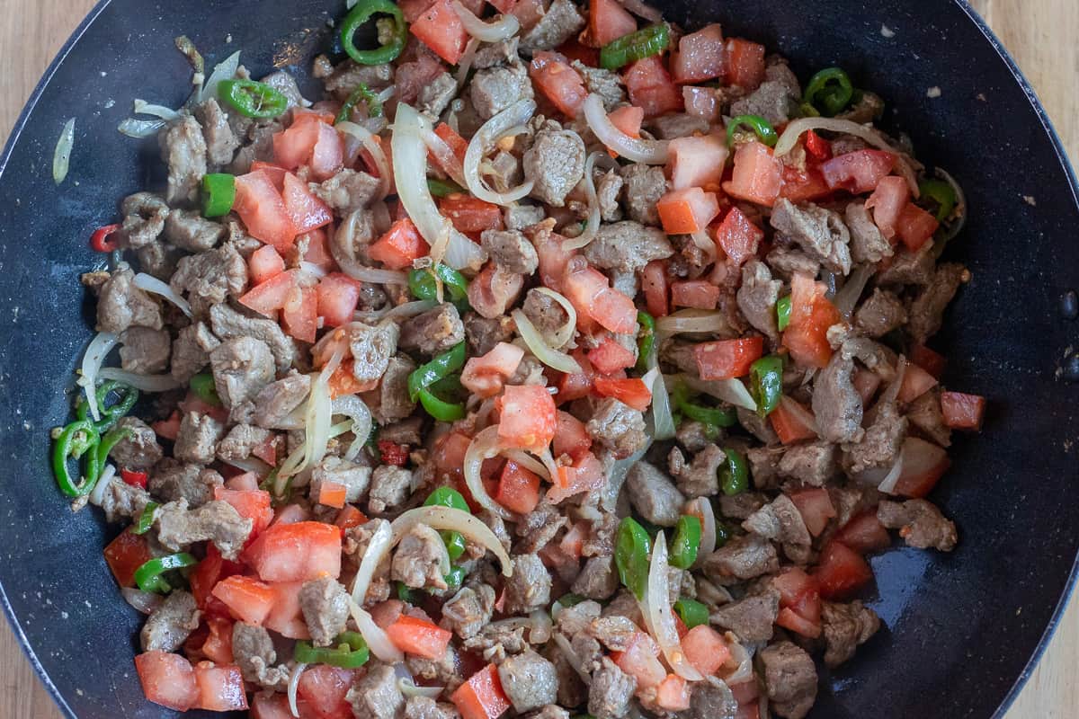 the tomatoes are added to sautéed lamb