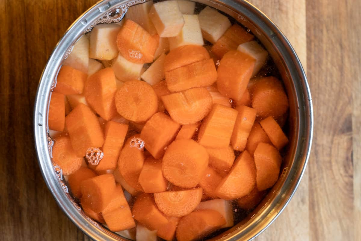 carrot and swede are placed in a pan with cold water