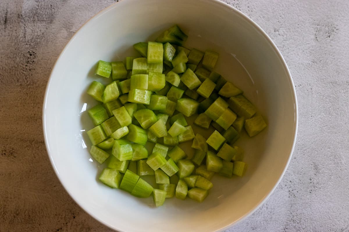Cucumbers are cut in small dices and placed in a bowl