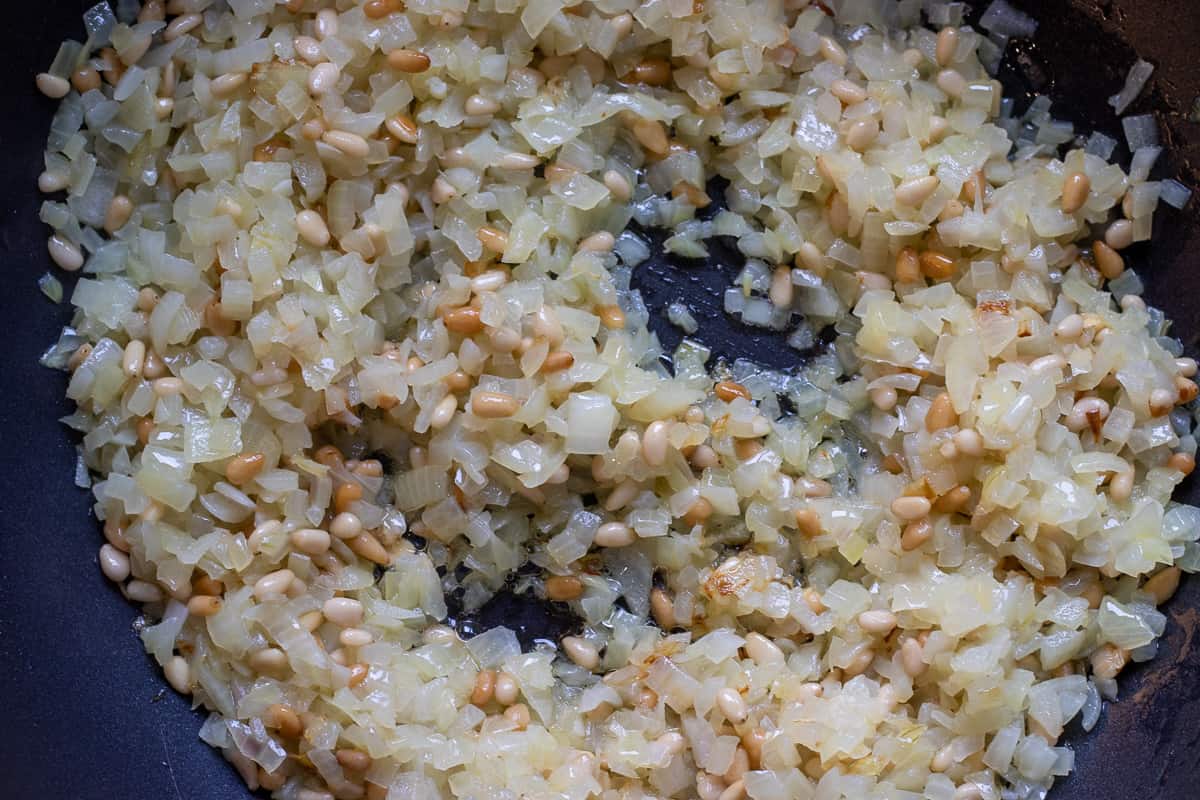 Sautéing the pine nuts until lightly browned