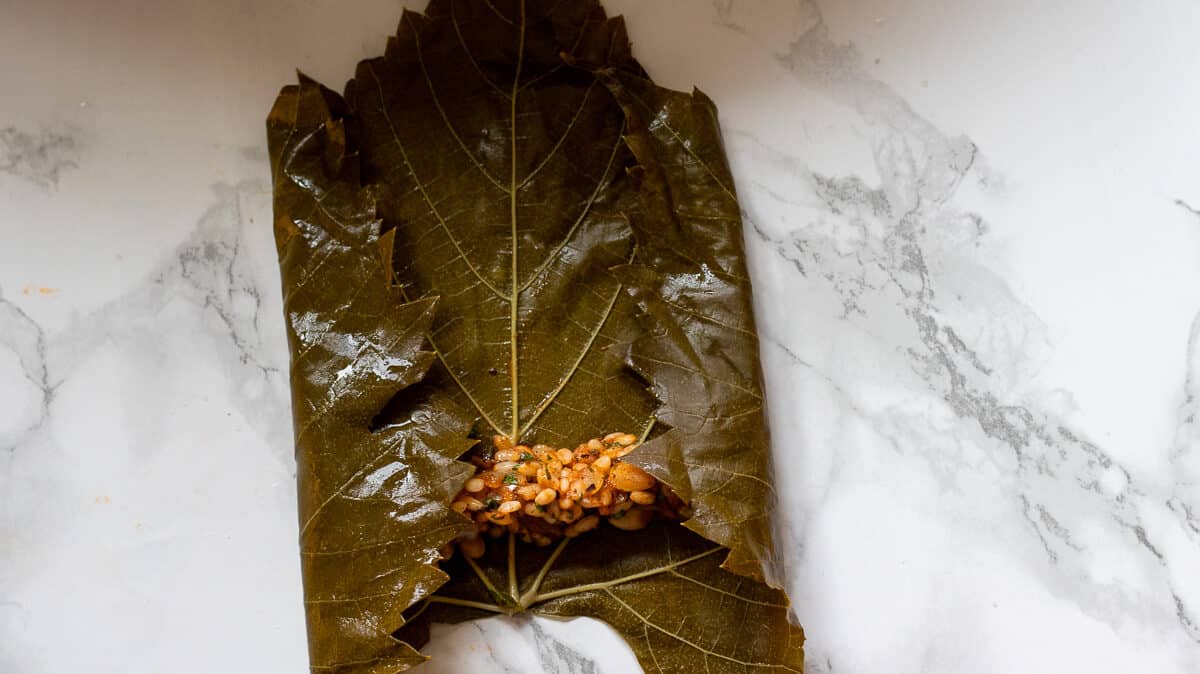 The sides of the grape leave is folded on the filling