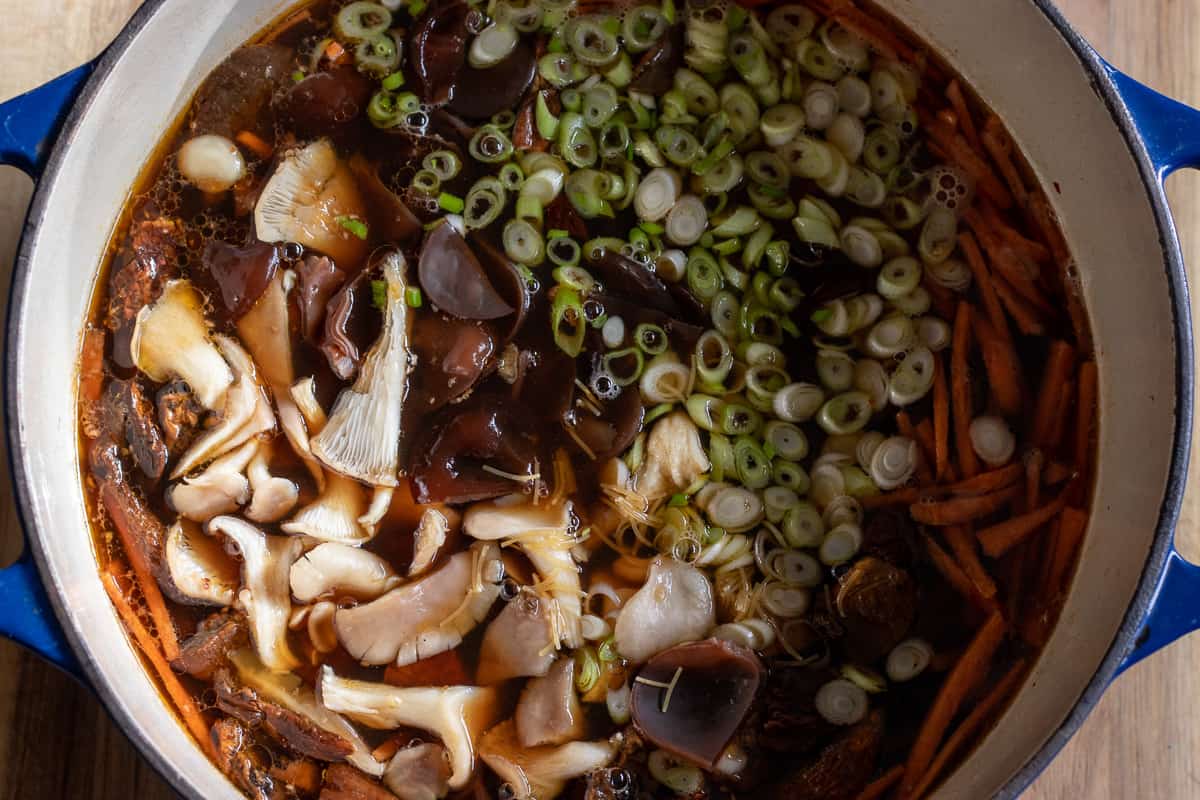 mushrooms, chicken, vermicelli and carrots are added to the broth