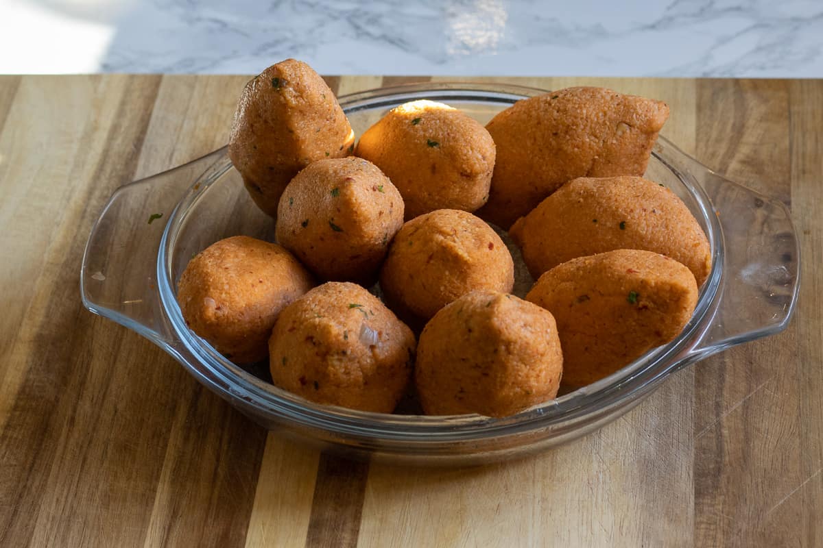 9 kibbeh balls are on a plate, ready for frying