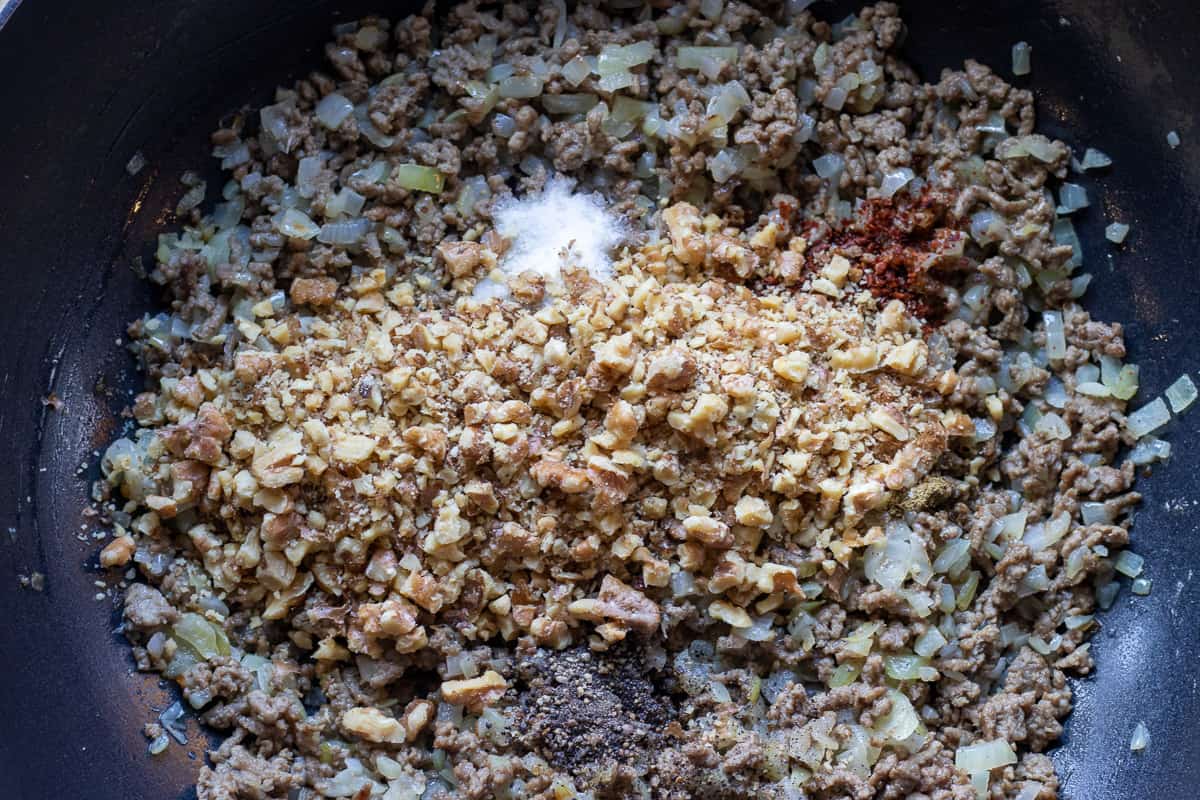 spices and walnuts are added to the mince mixture