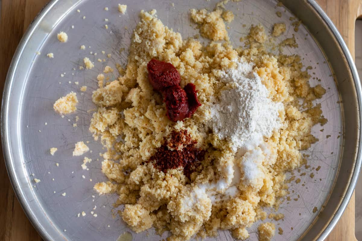 tomato - pepper paste, flour and spices are added to there semolina mixture