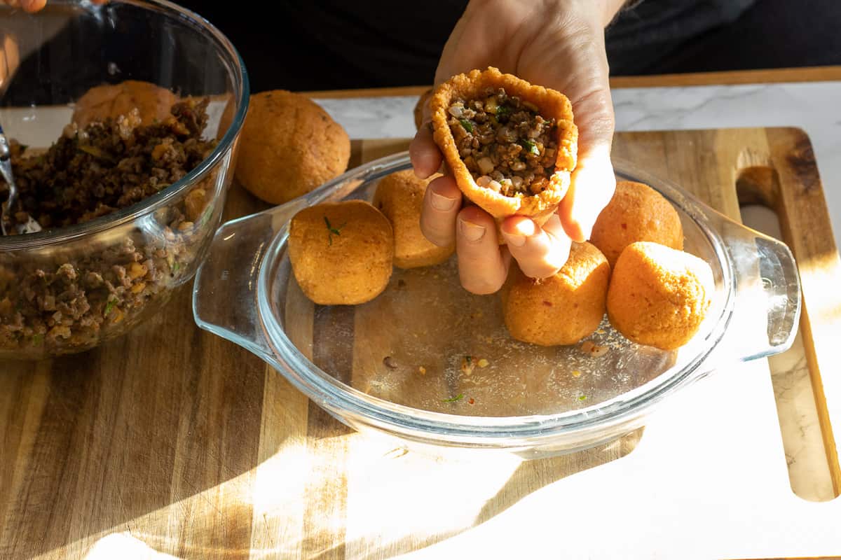 placing the filling into the hollowed ball