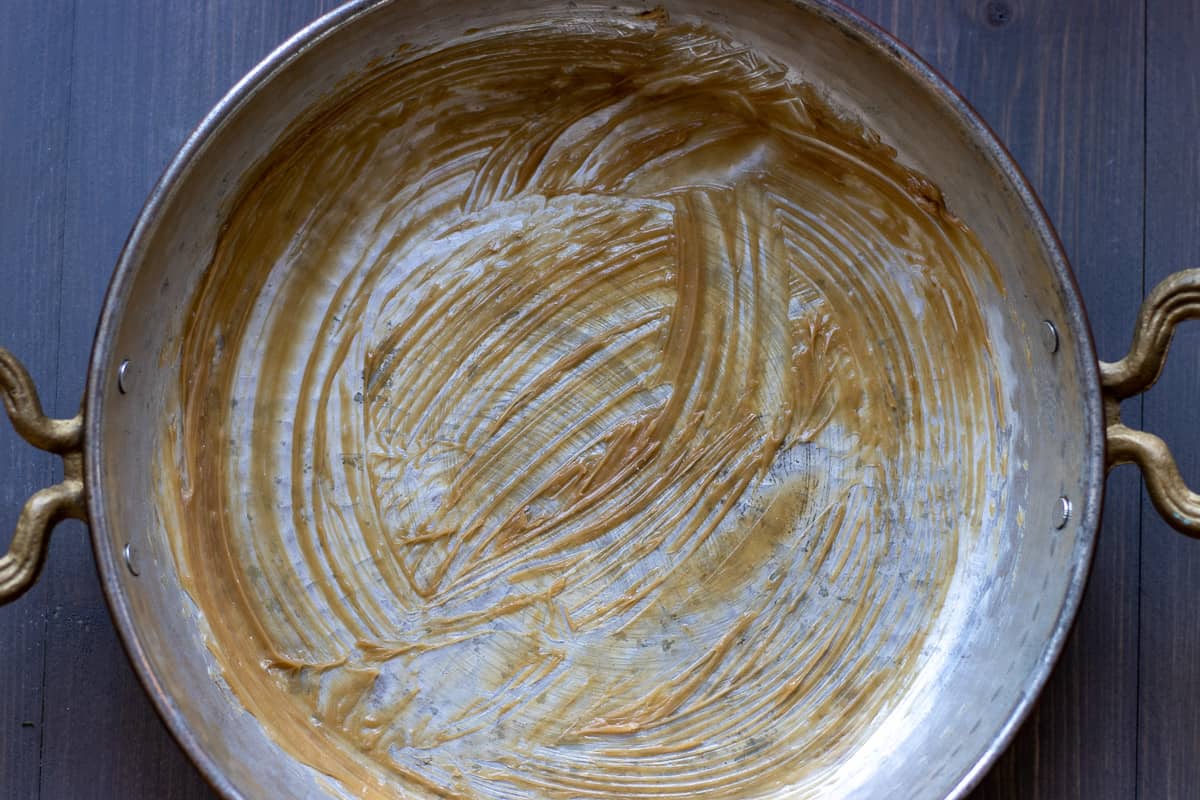 soft butter is spread to the bottom of the pan