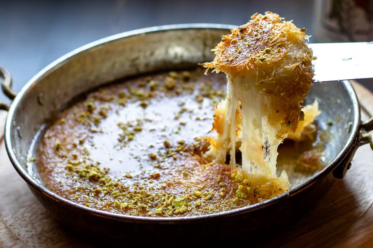 A slice of freshly made Kunefe - Turkish Cheese Dessert