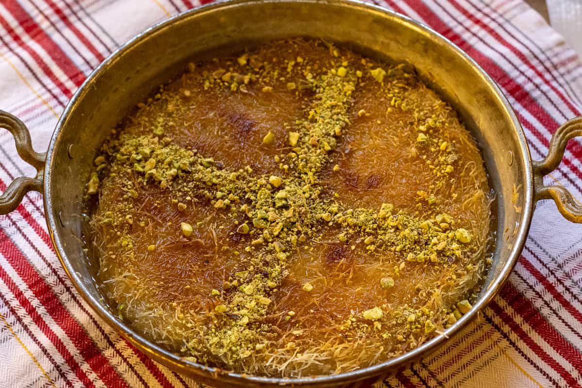 kunefe dessert is garnished with pistachio nuts