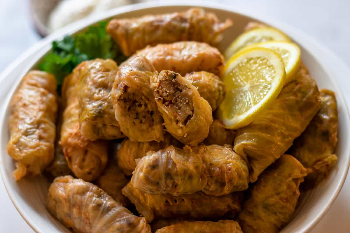 lahana Sarmasi on a plate with lemon slices