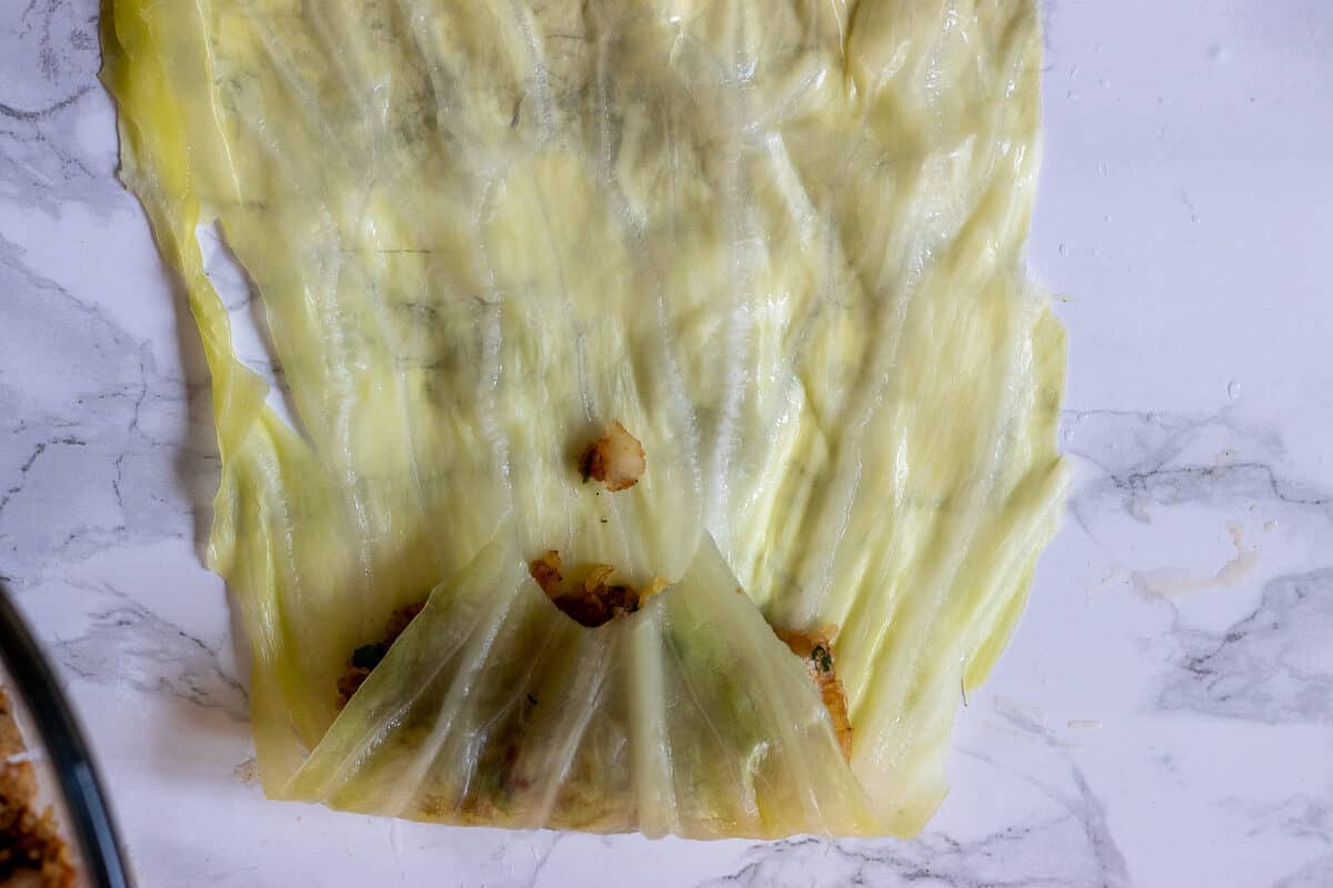 rolling the leave up to cover the filling