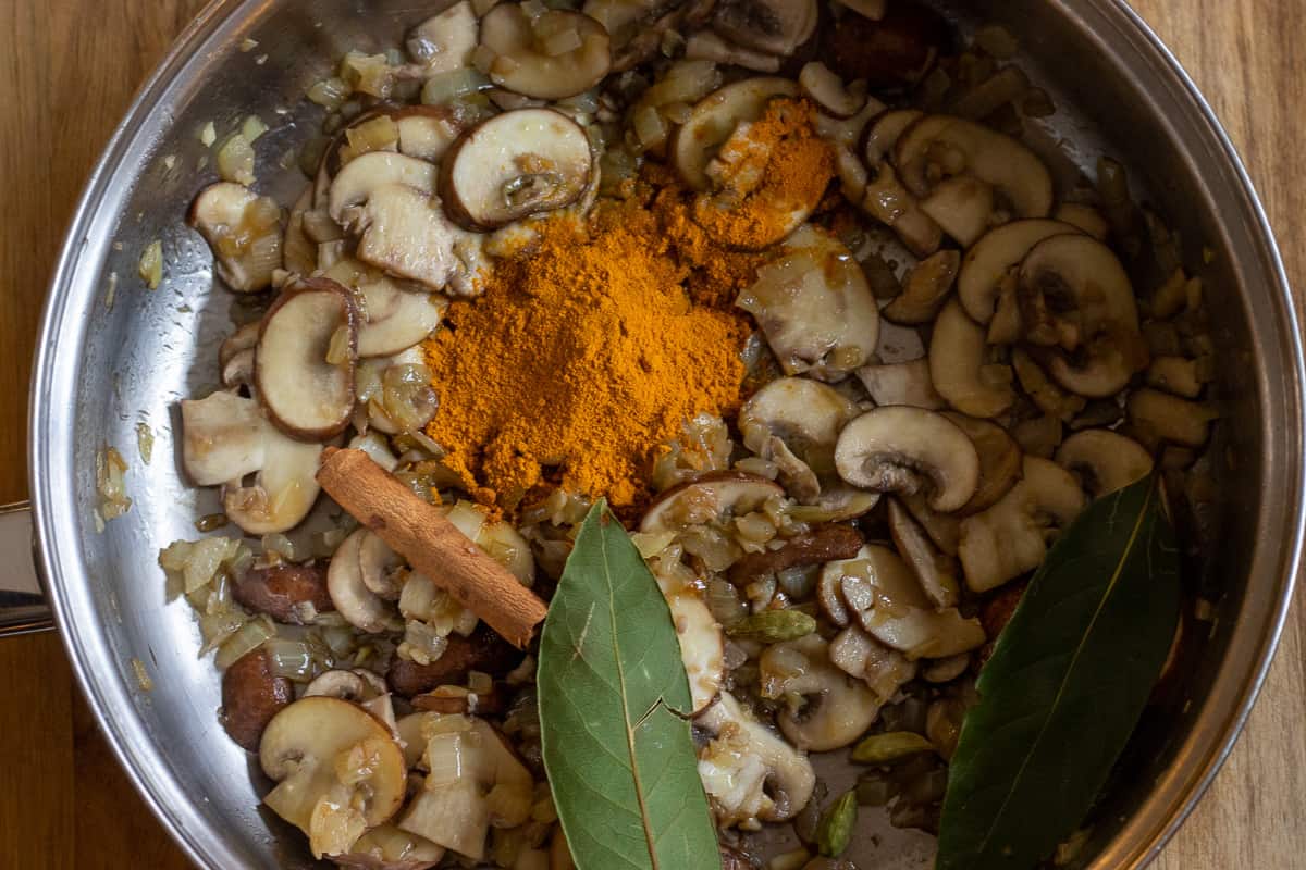 the aromatics and spices are added to sautéed mushrooms