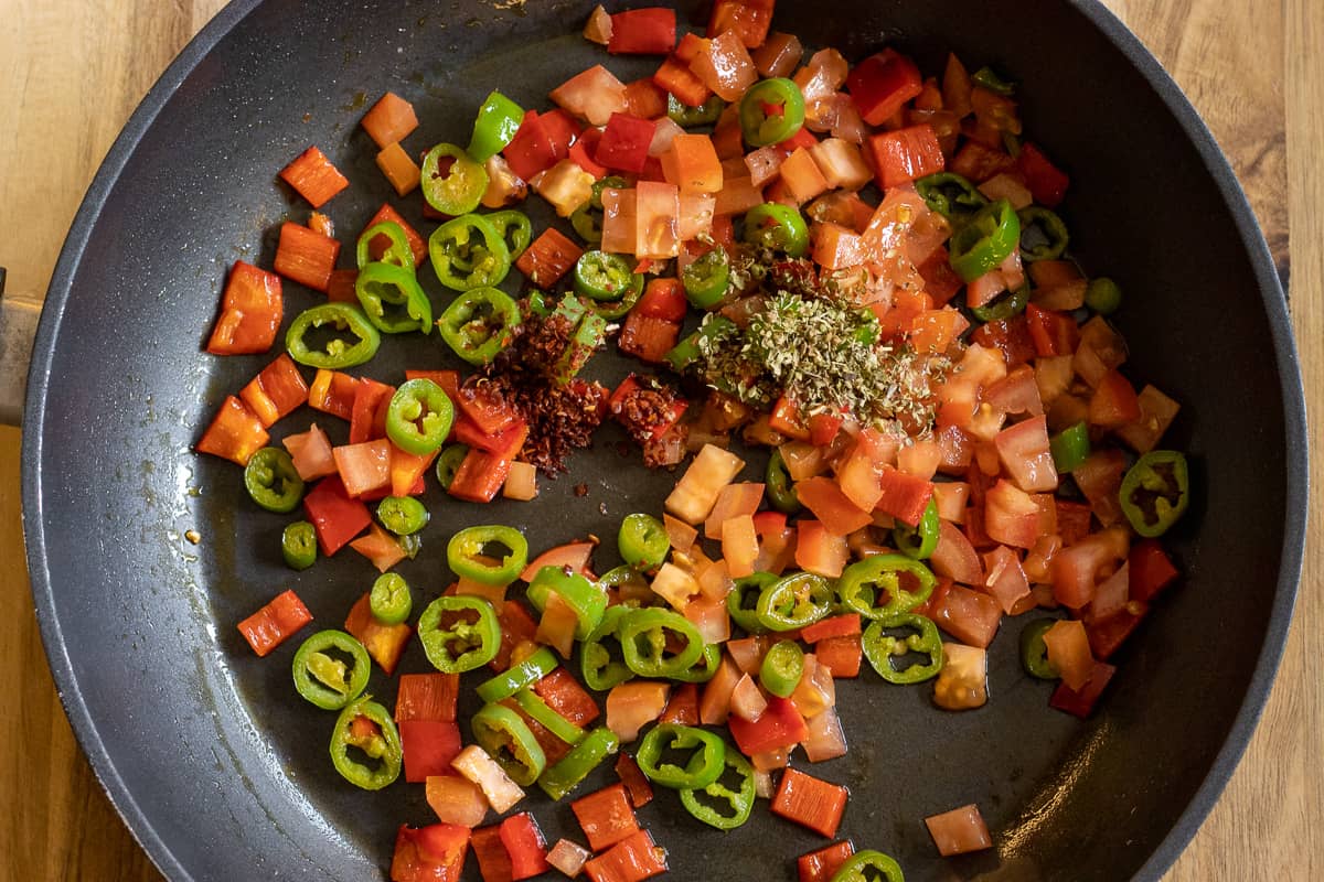 the tomatoes and spices are added to peppers
