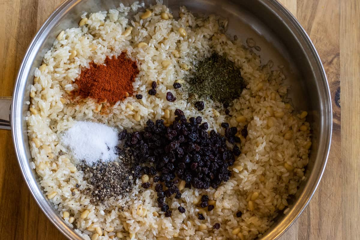 the currants and spices are added to the rice and pine nuts