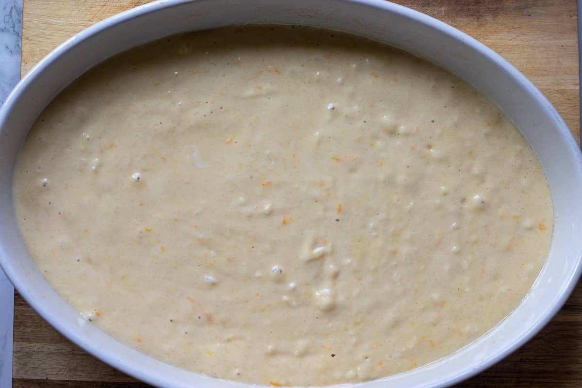 revani cake mixture is poured in a baking dish
