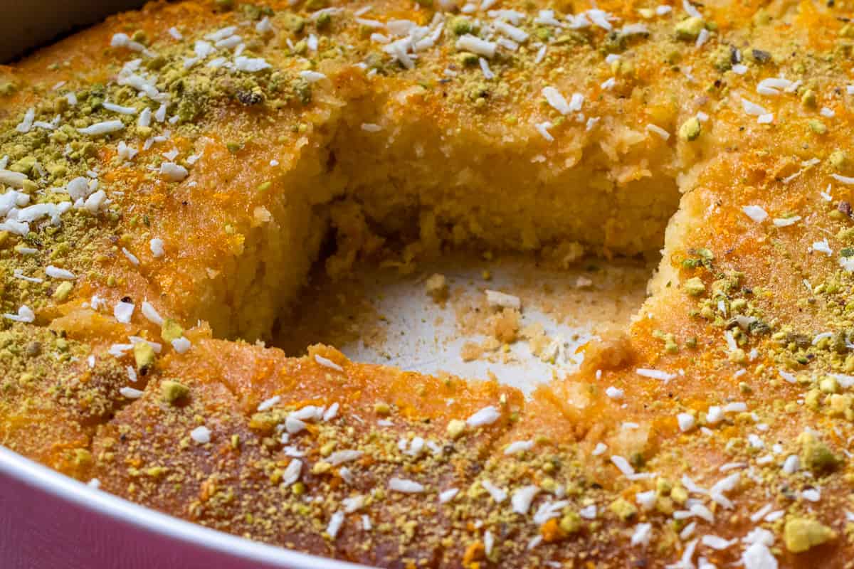 2 pieces of revani cake triangles are removed from the tray