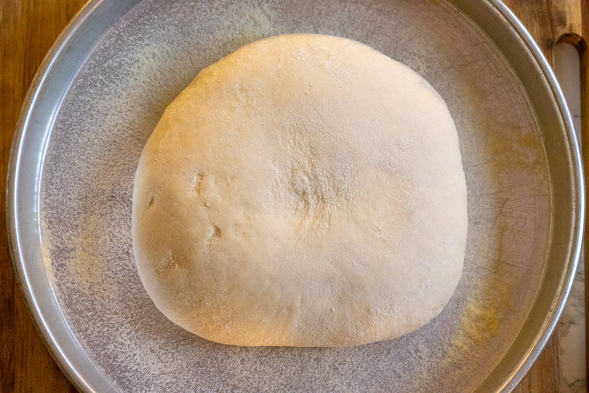 turkish pide bread is placed on a tray to rest for 15 minutes
