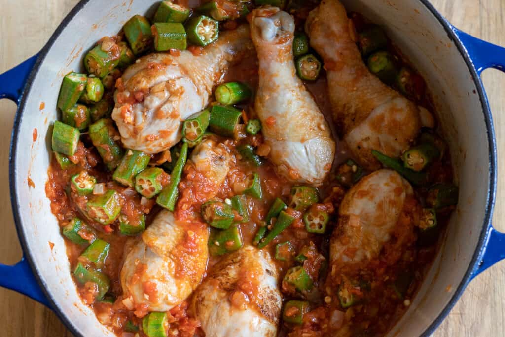 Stock and bamya are added to the pot.