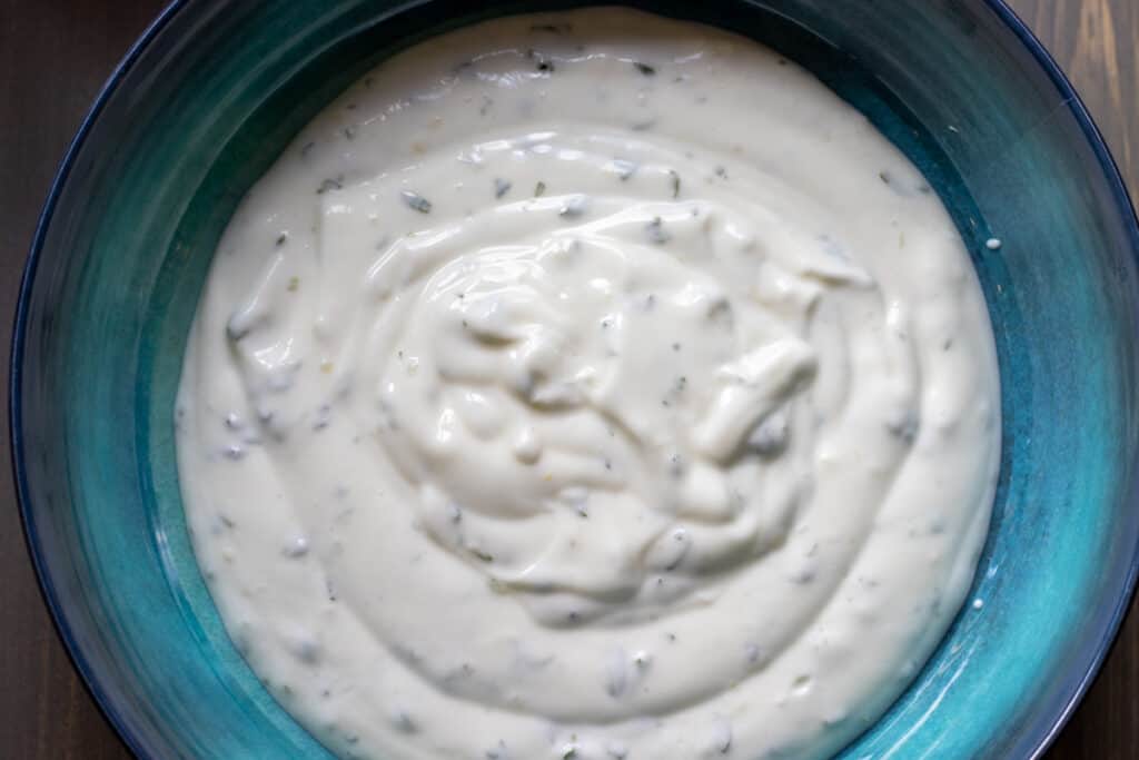 the garlicky yoghurt is transferred to a serving plate