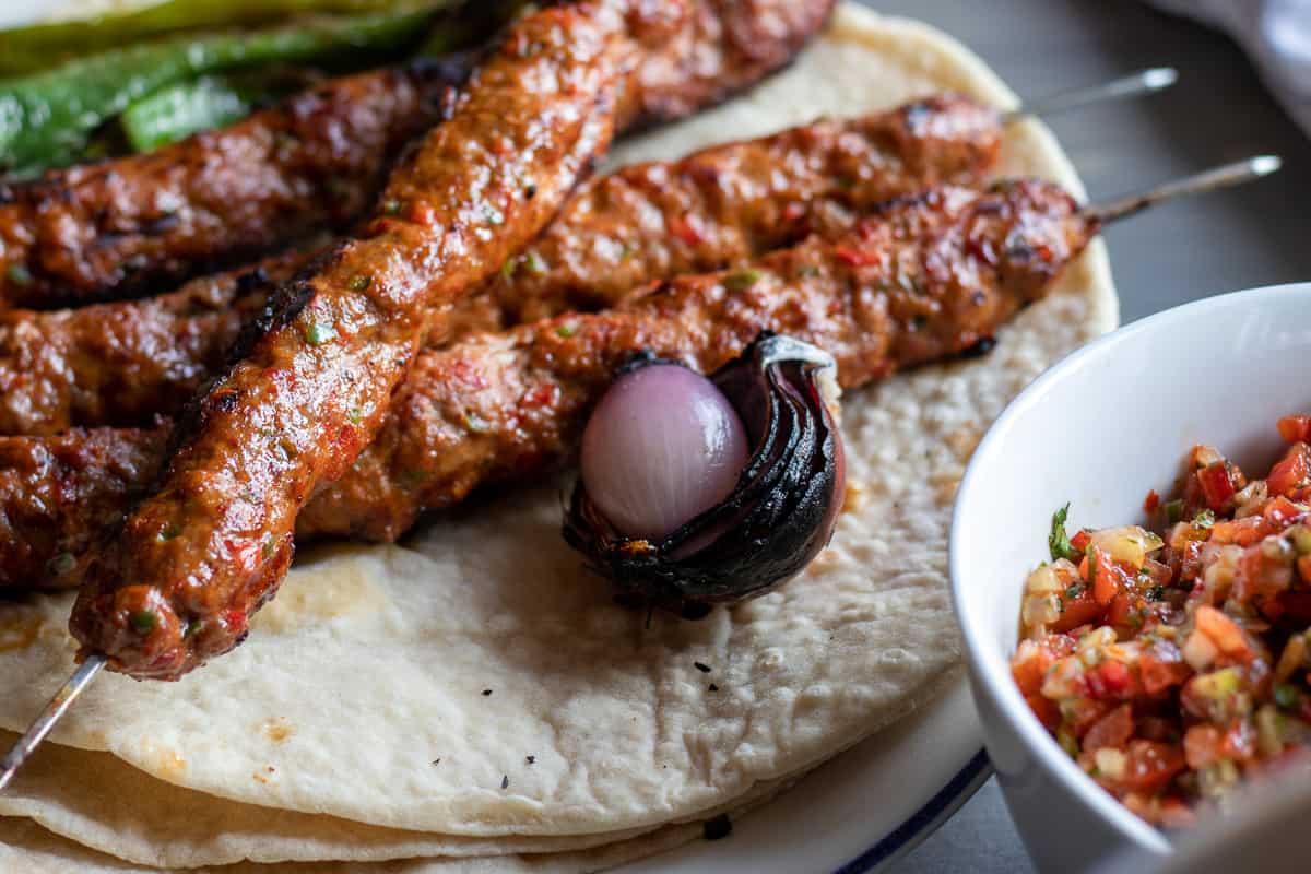 acili ezme salad served with Adana Kebab