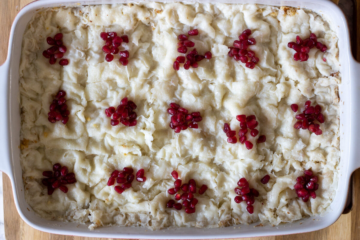 Gullac is portioned and garnished with pomegranate seeds