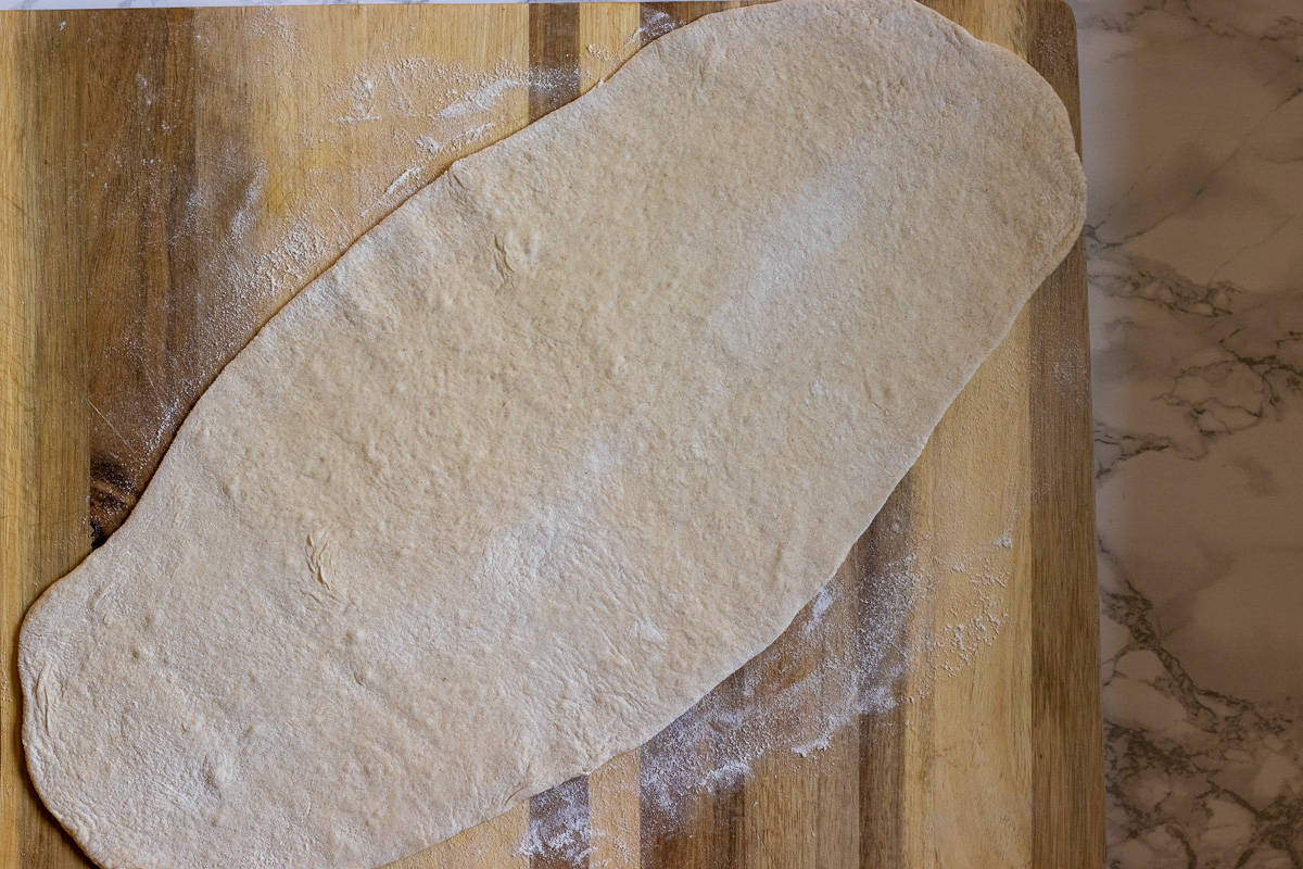 The dough is rolled out in an oval shape