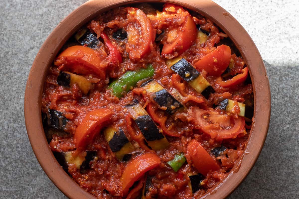 the sauce is pored over patlican kebabi