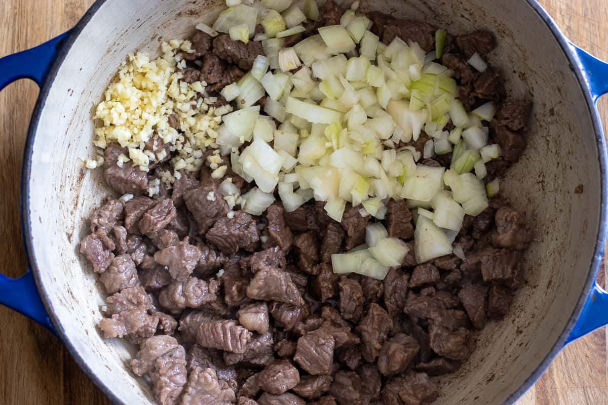 add the onions and garlic, sauté until soft