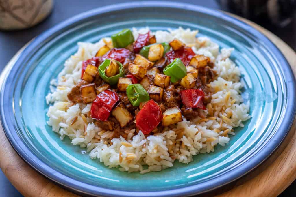 serve Tas Kebabi on a bed of rice