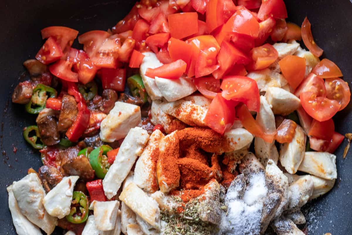 the tomatoes and spices are added to the pan