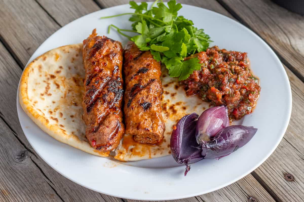 acili ezme served with adana kebab and pita bread