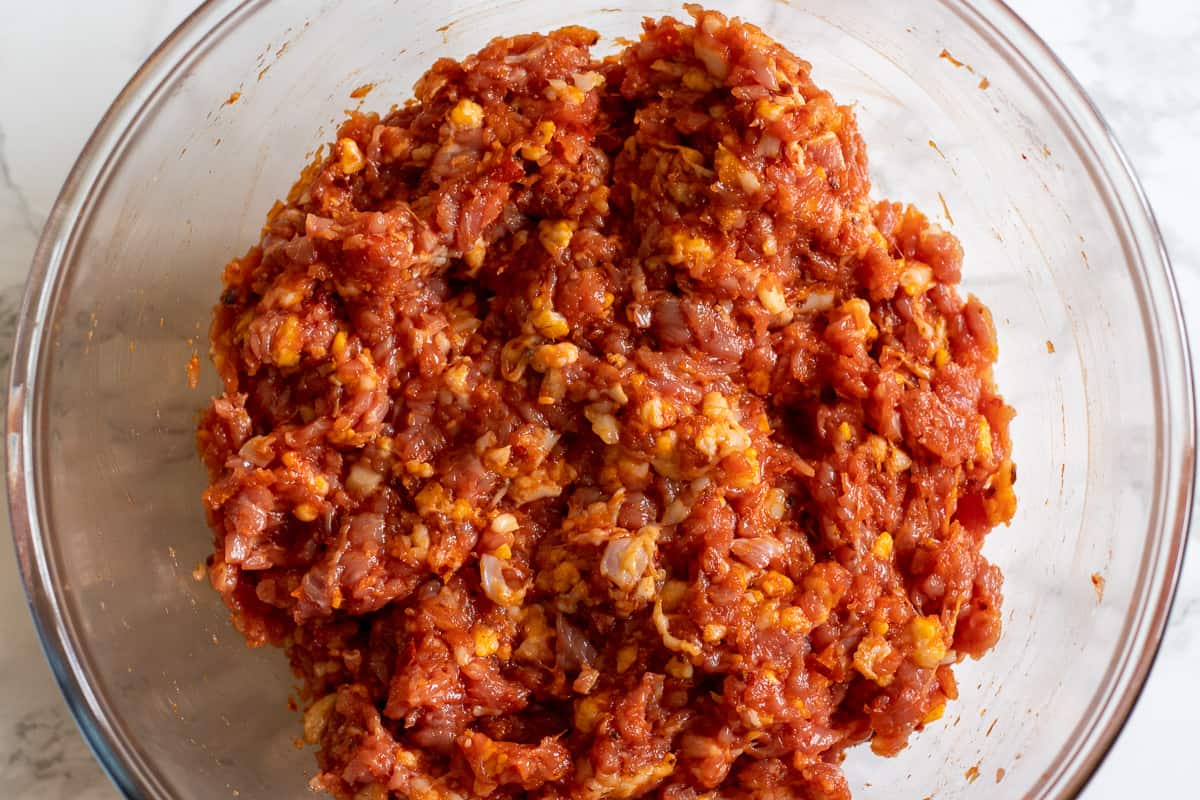 Adana Kebab ingredients mixed in a glass bowl