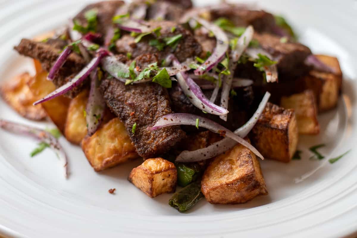 arnavut cigeri served with cubed potatoes and onion salad