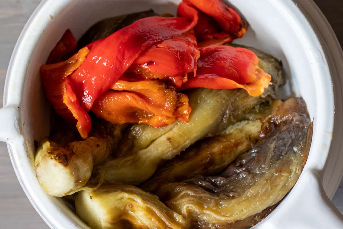 peeled aubergines and peppers placed on a colander
