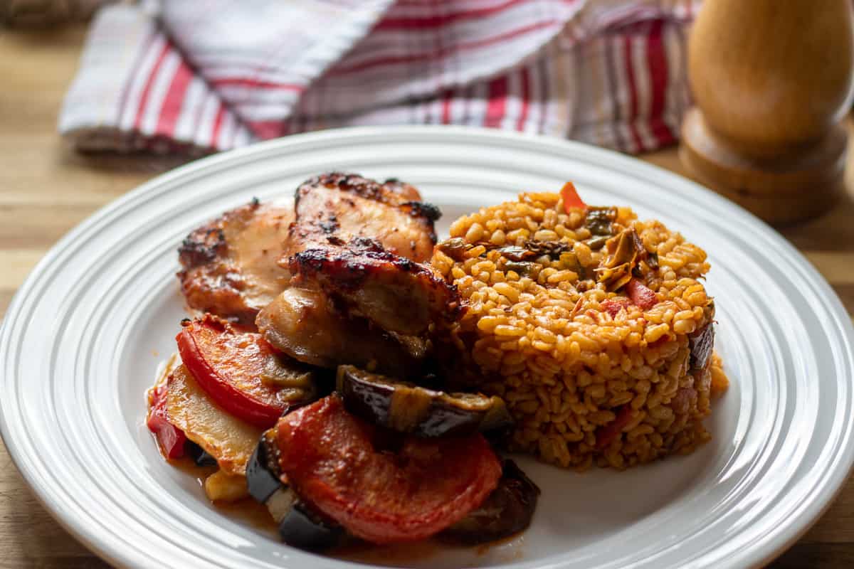 baked boneless chicken thighs served with bulgur Pilavi