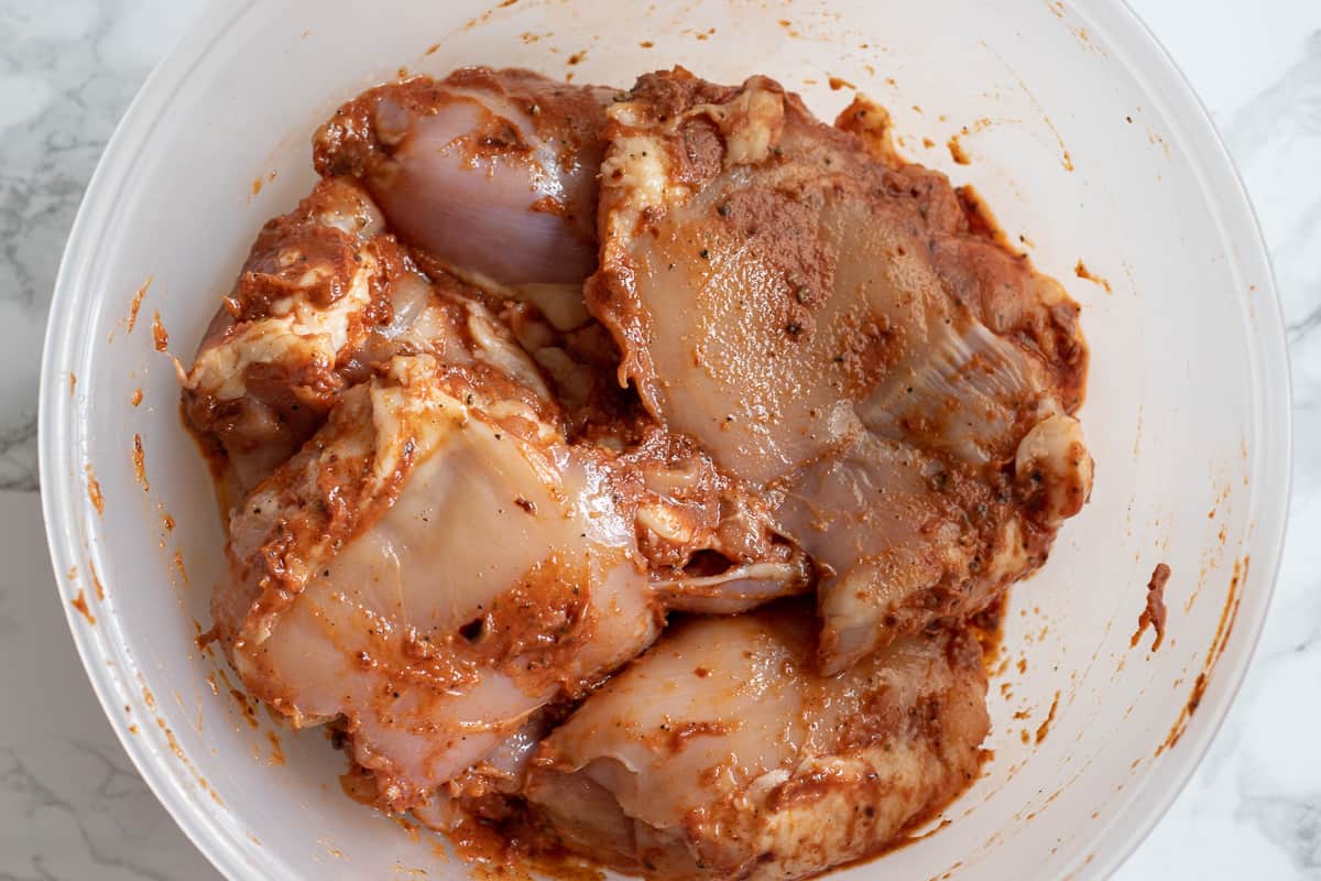 The chicken thighs are covered with marinade