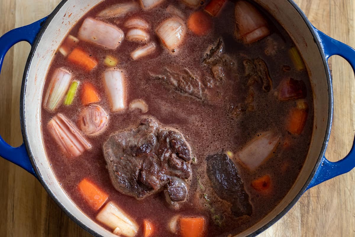 The vine and the stock added to the pan